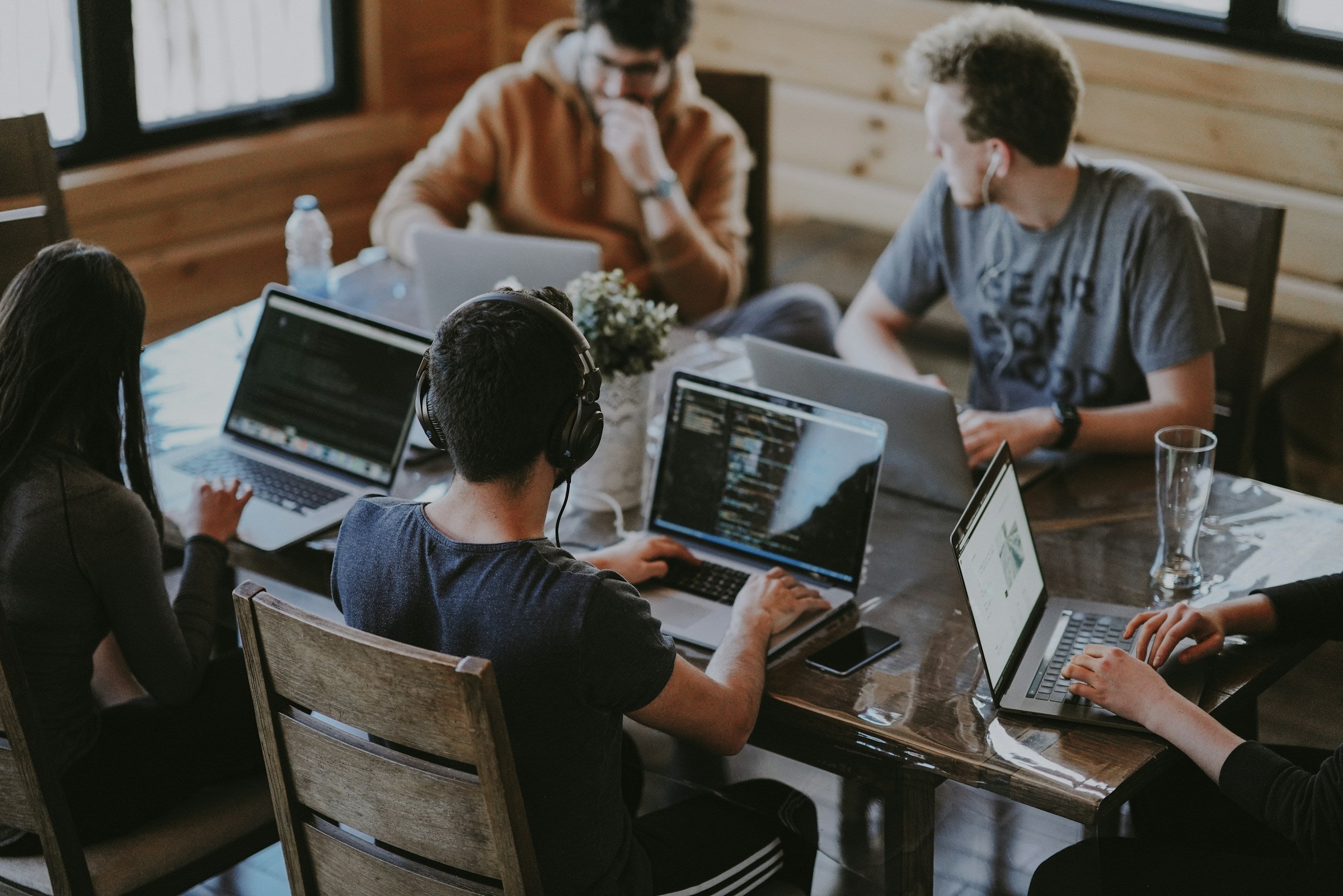 Software engineers pair-programming around a shared table